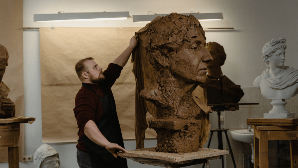 a man holding a sculpture