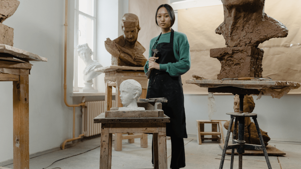 a woman doing face sculpture