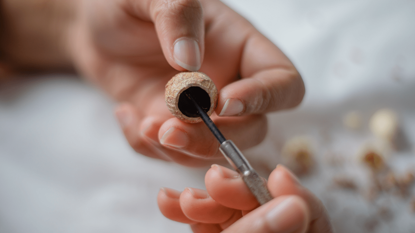 a man refining the texture of a miniature scupture