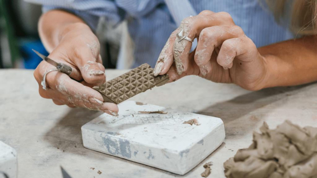 a man sculpting a little object