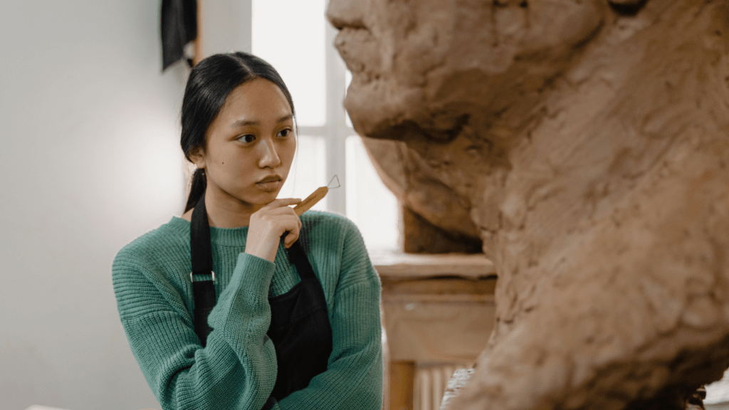 a sculptor staring a a sculpture