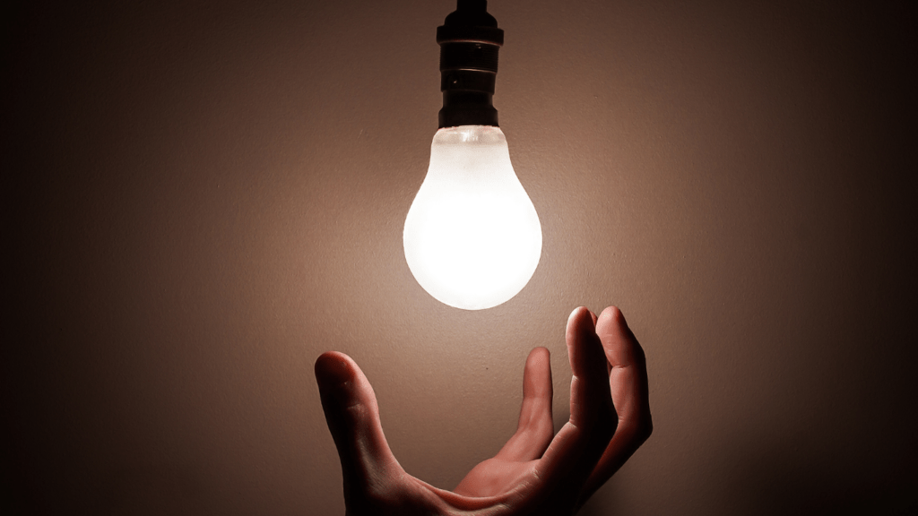 a hand and a bulb as a sign of idea