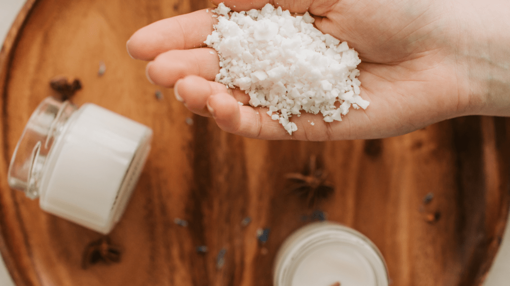 a hand with a wax products