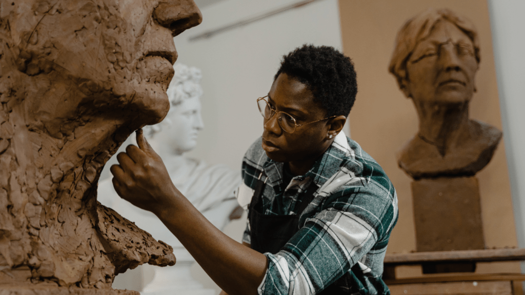 a man doing clay sculpture