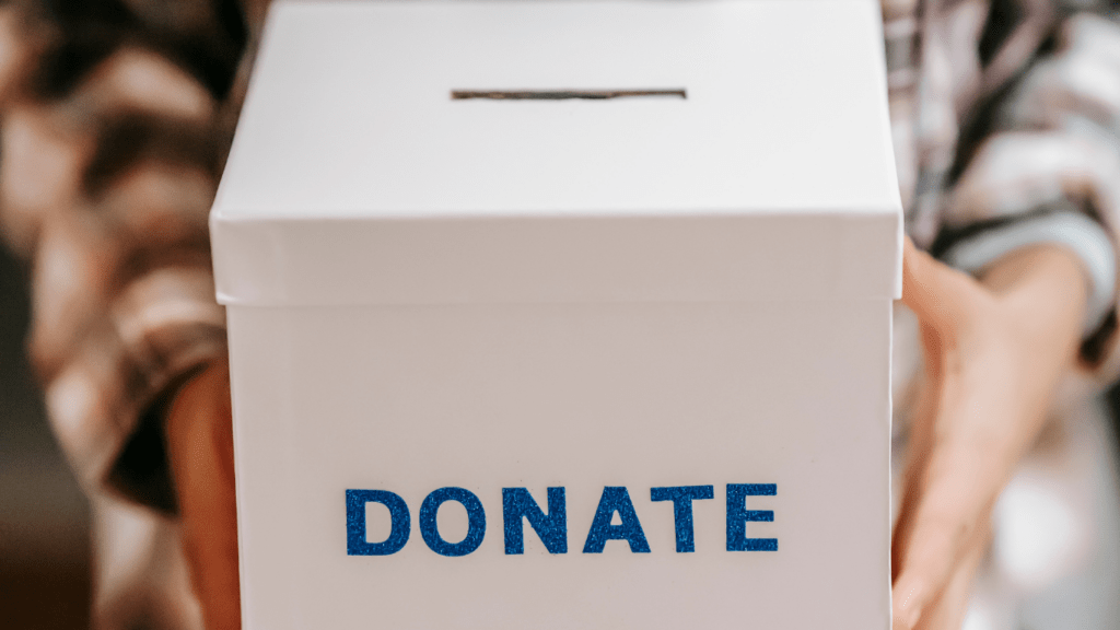 a man holding a donation box for fundraising