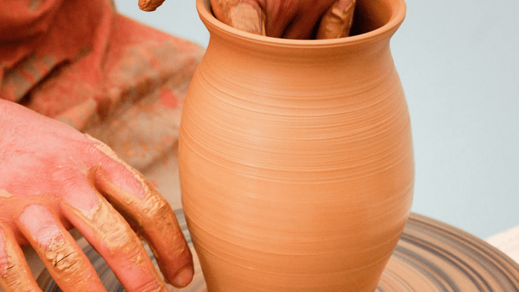 a man using clay in sculpting