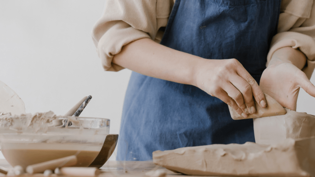 a woman doing clay sculpting