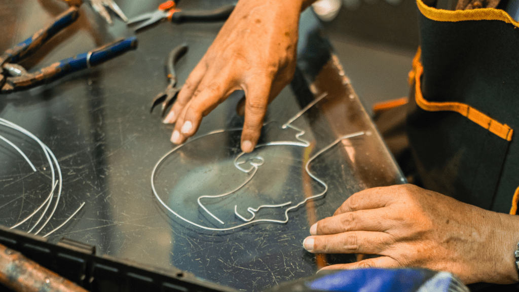 man doing metal sculpting